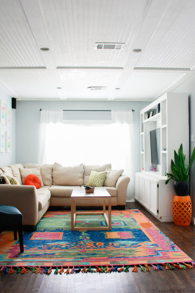 amazing colorful living room with DIY entertainment center and colorful rug