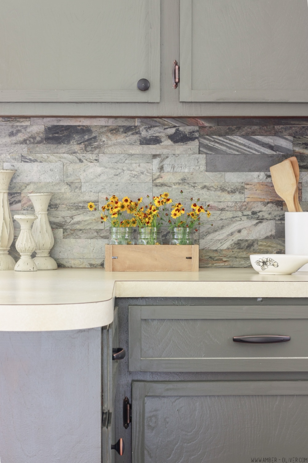 Kitchen remodel on a budget! Dark painted cabinets, peel and stick backsplash, and updated old cabinet doors!