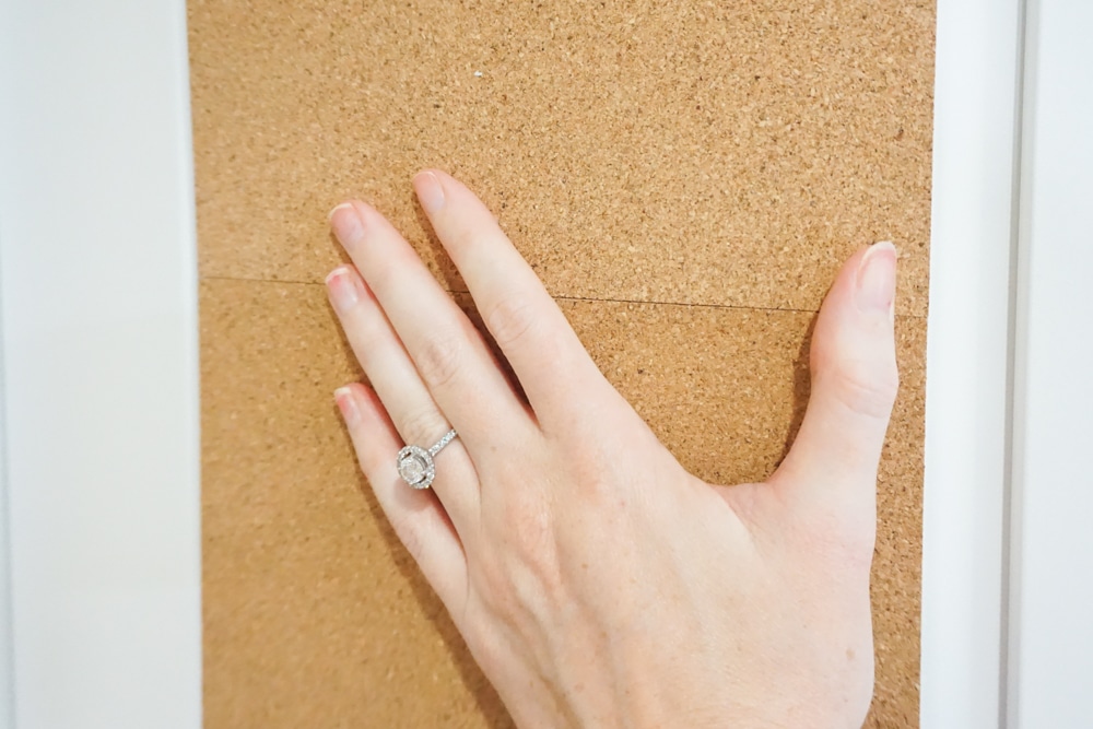 putting cork in cabinet to help organize a baking cabinet