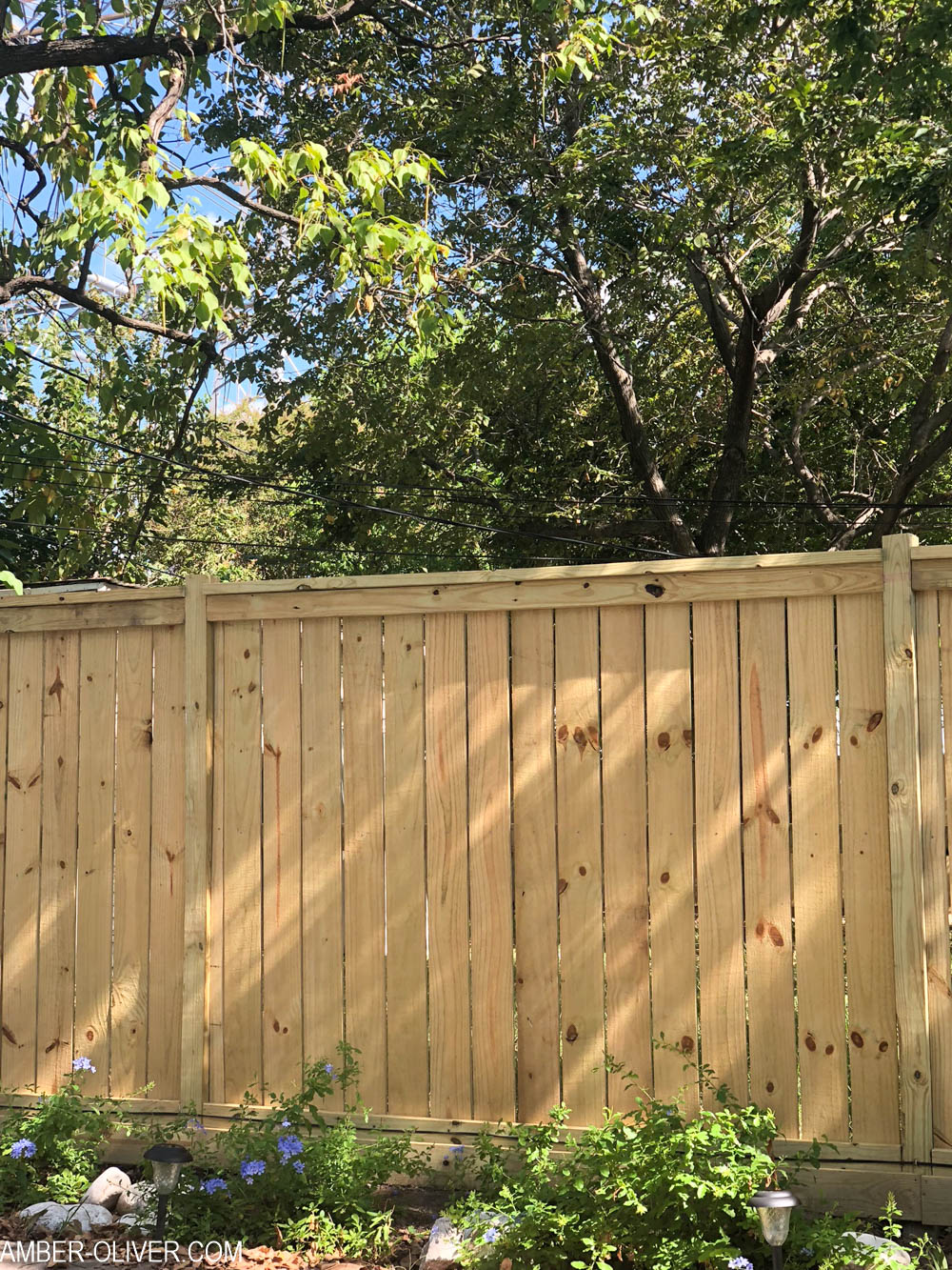 A beautiful DIY fence with a tutorial for how to build a fence