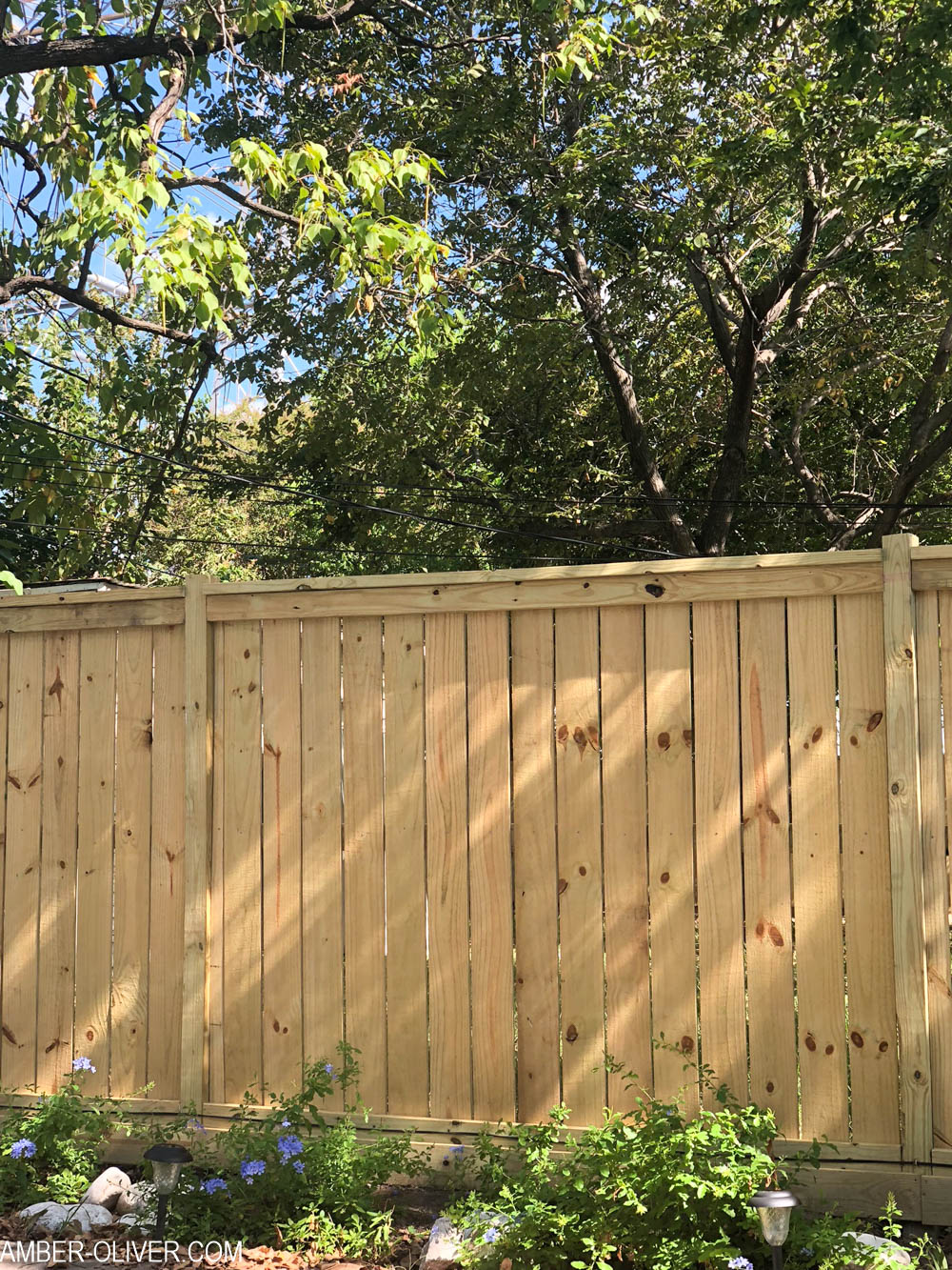 A beautiful DIY fence with a tutorial for how to build a fence 