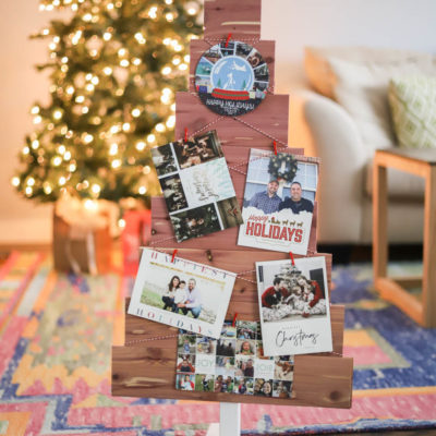 DIY christmas card holder in front of a brightly lit tree