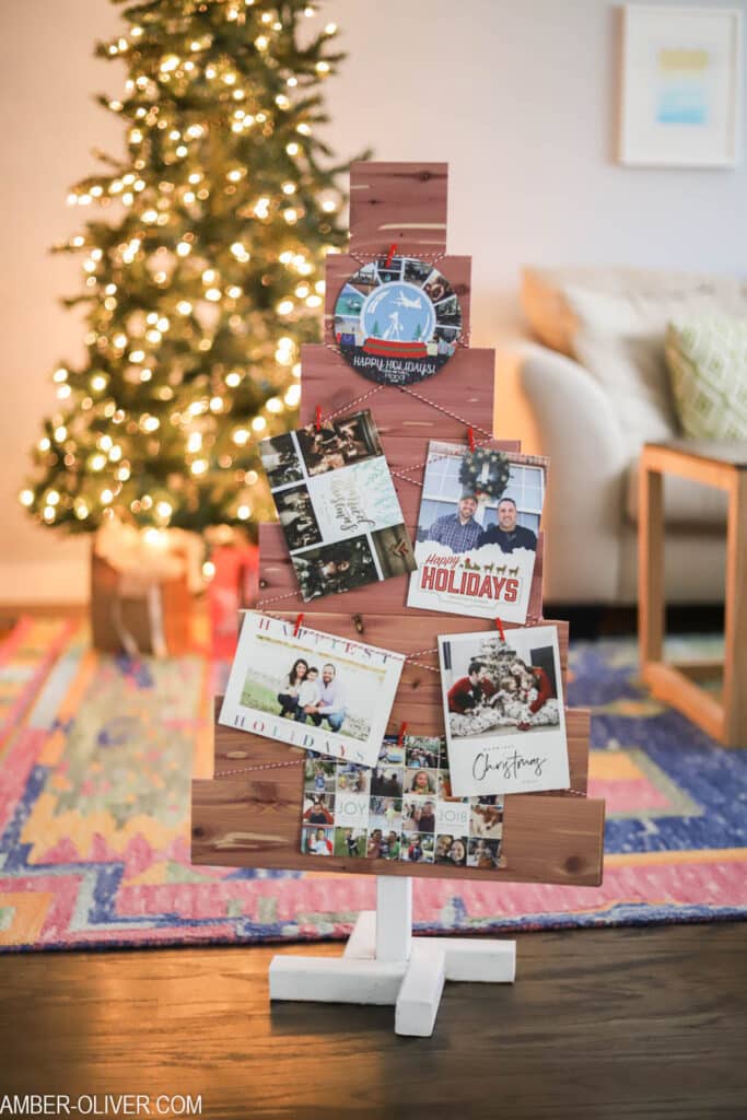 DIY christmas card holder in front of a brightly lit tree