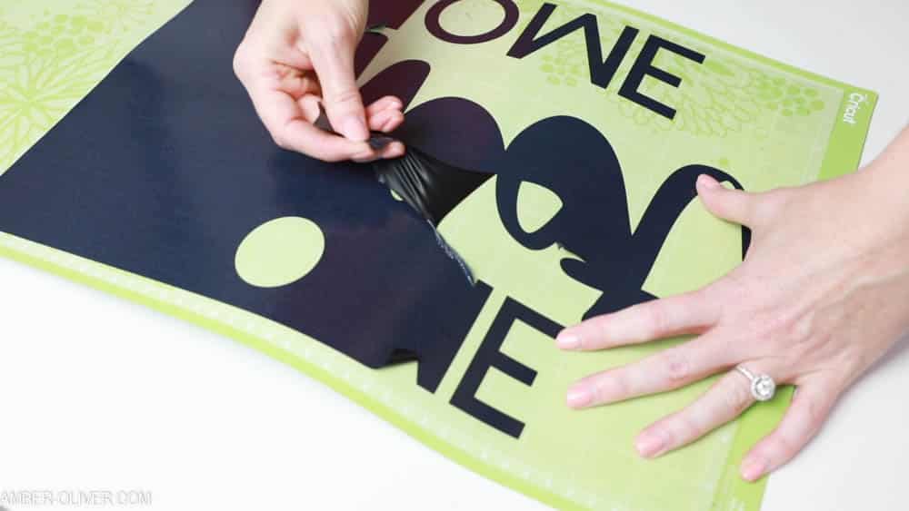 removing excess vinyl to create reverse canvas signs