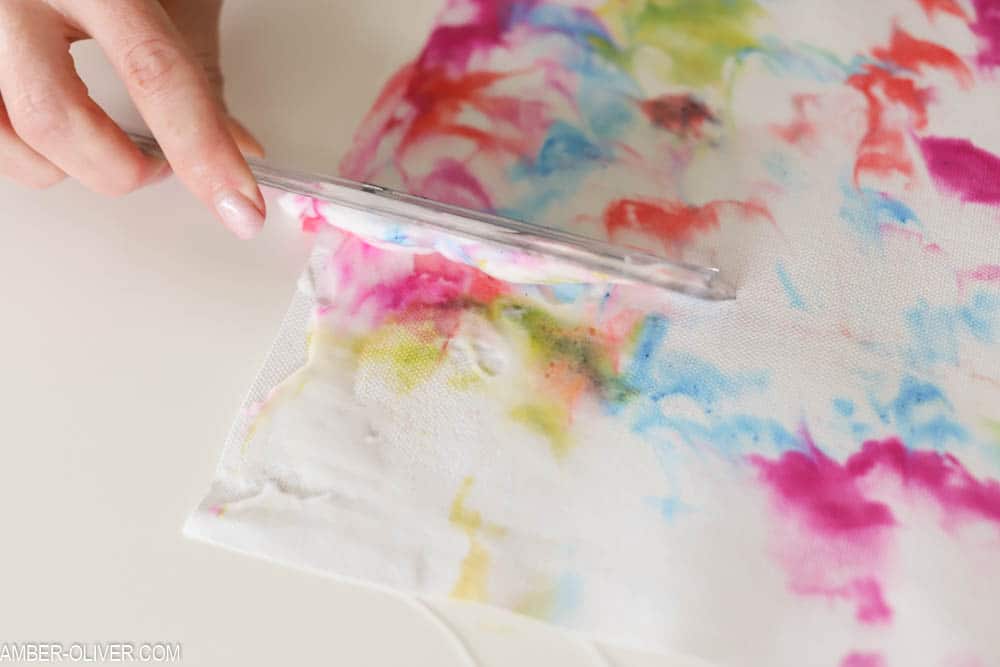 wiping away excess shaving cream on diy wall hanging