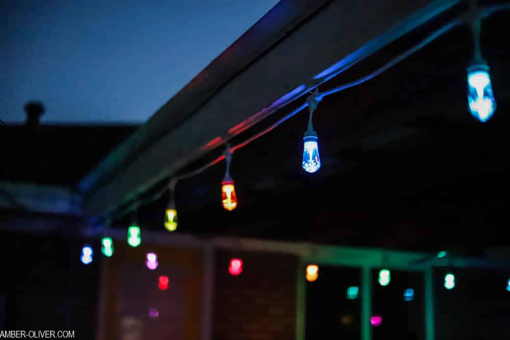 led color changing lights hanging in the dark on a patio outside