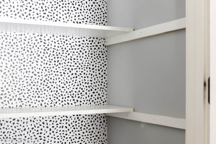 peel and stick wallpaper in a pantry with white shelves