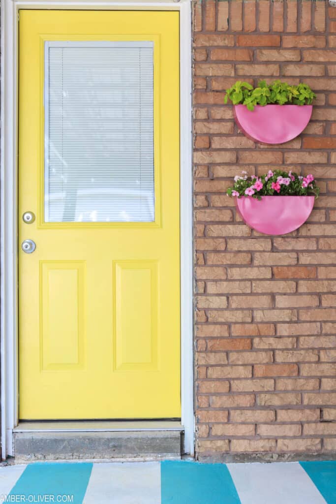 yellow backdoor with pink painted metal planters