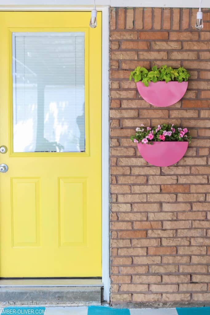 painted metal planters hanging by back door