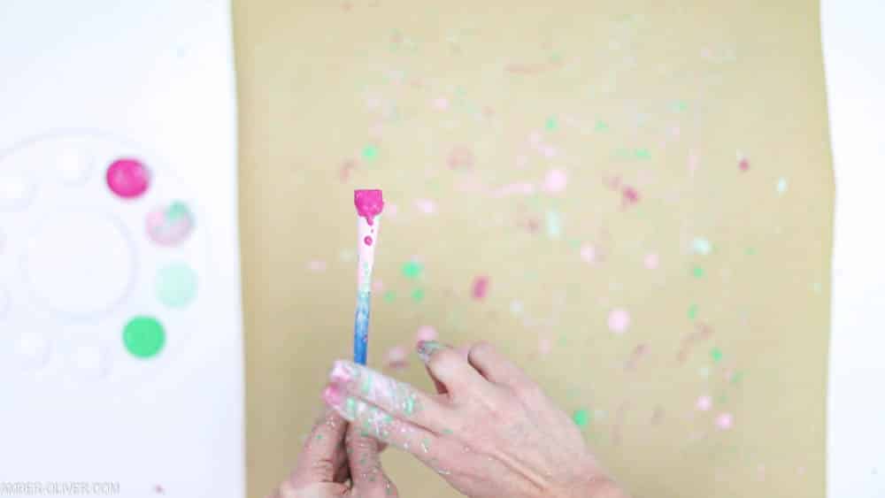 adding paint splatters to gift wrap