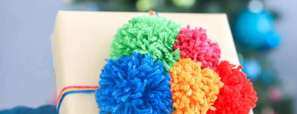 colorful handmade pom poms for creative gift wrap