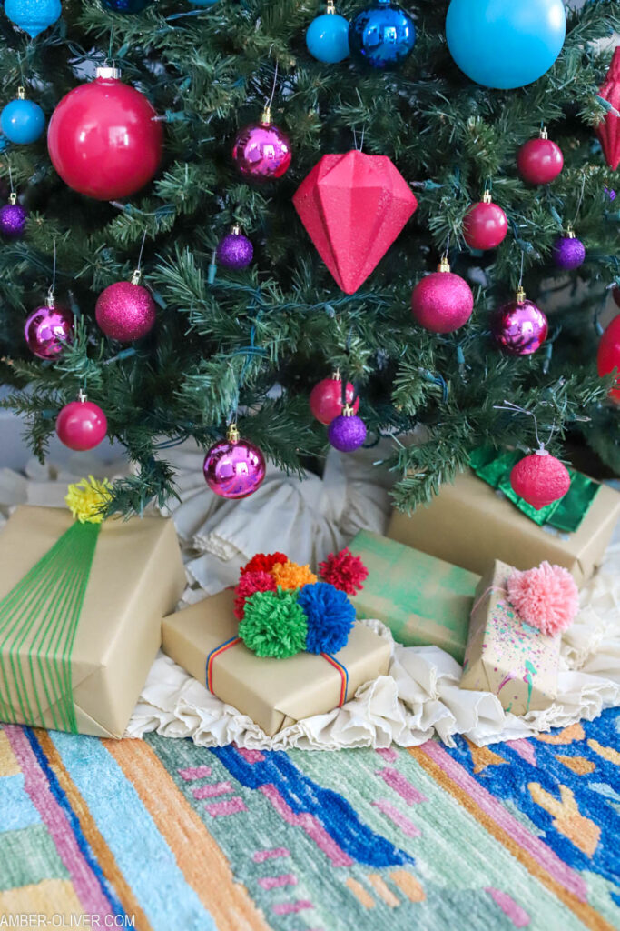 rainbow christmas tree with creative gift wrap underneath