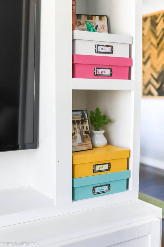 colorful diy memory boxes stacked in a DIY entertainment center