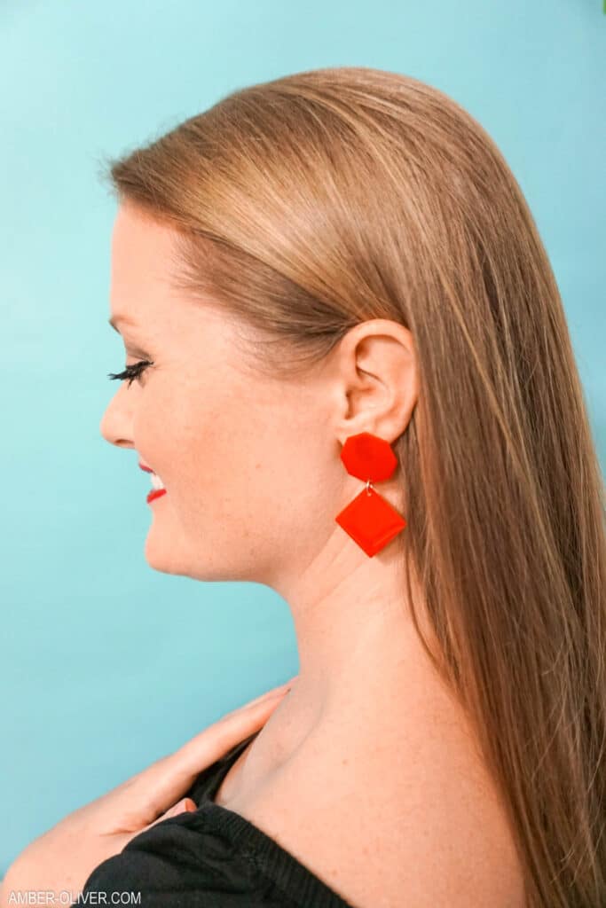 close up view of red diy earrings made from resin