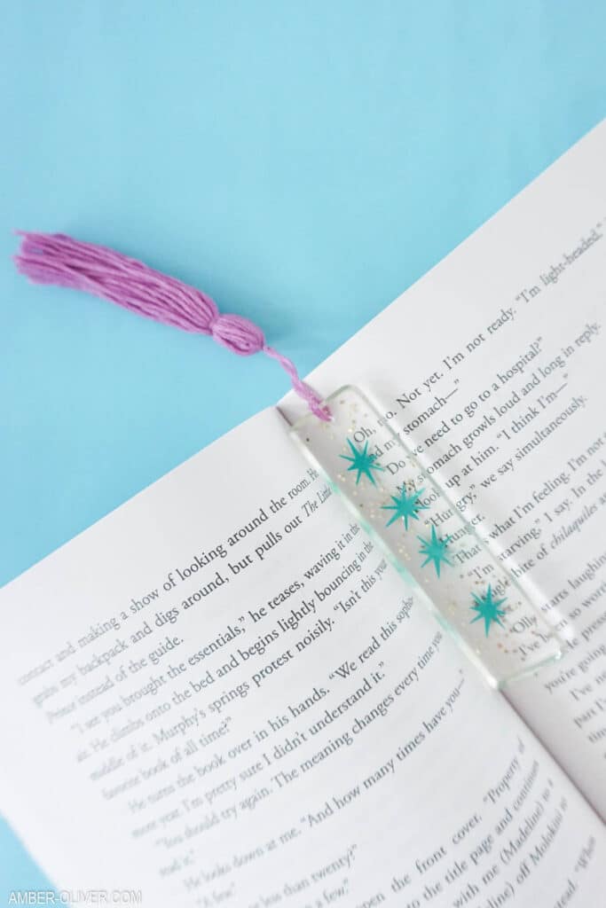 a diy resin bookmark in the pages of a book