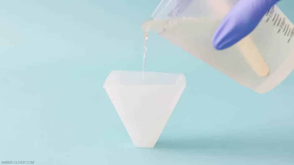 pouring resin into a pyramid silicone mold