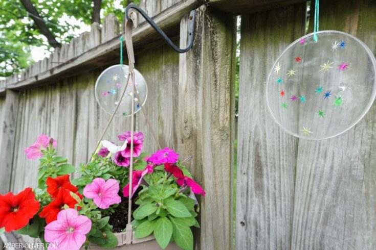 diy suncatchers from resin hanging on an old fence