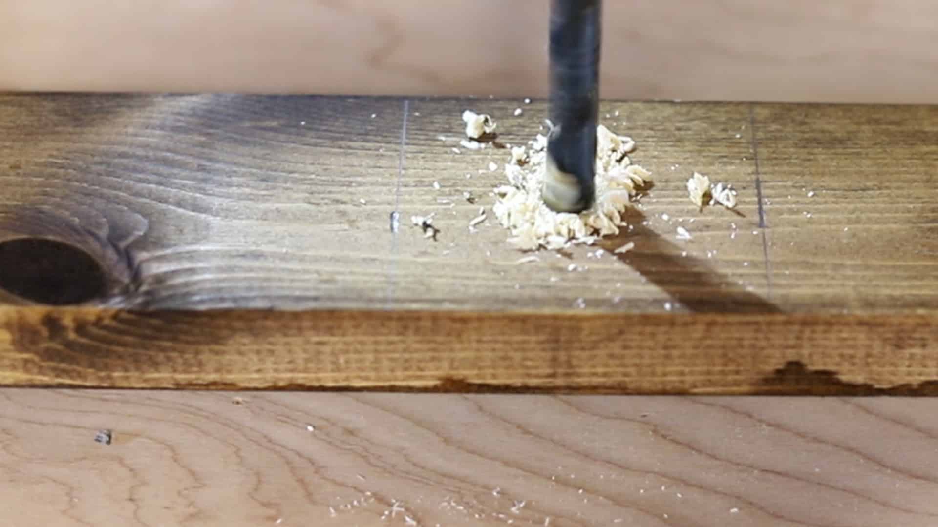 drilling holes to make a DIY blanket ladder