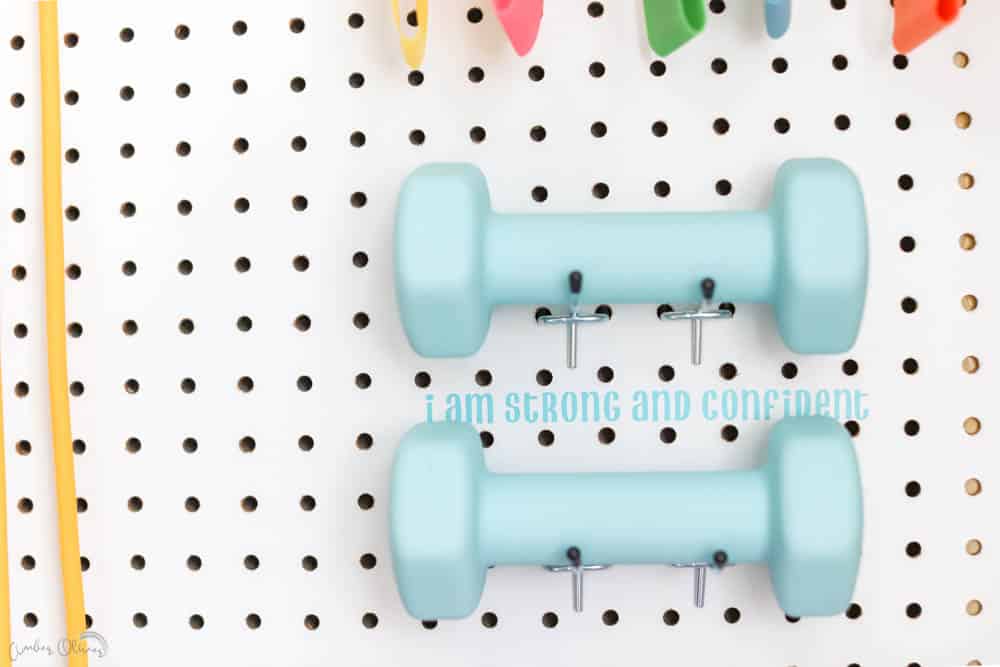 close up of workout affirmations on DIY pegboard
