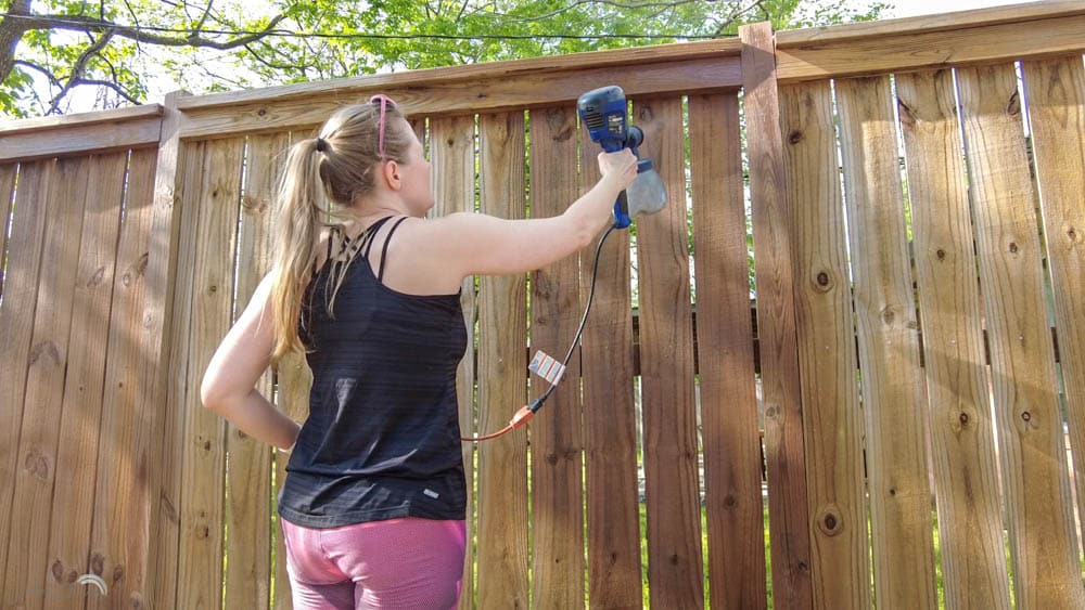 stain a fence quickly and easily with a paint sprayer