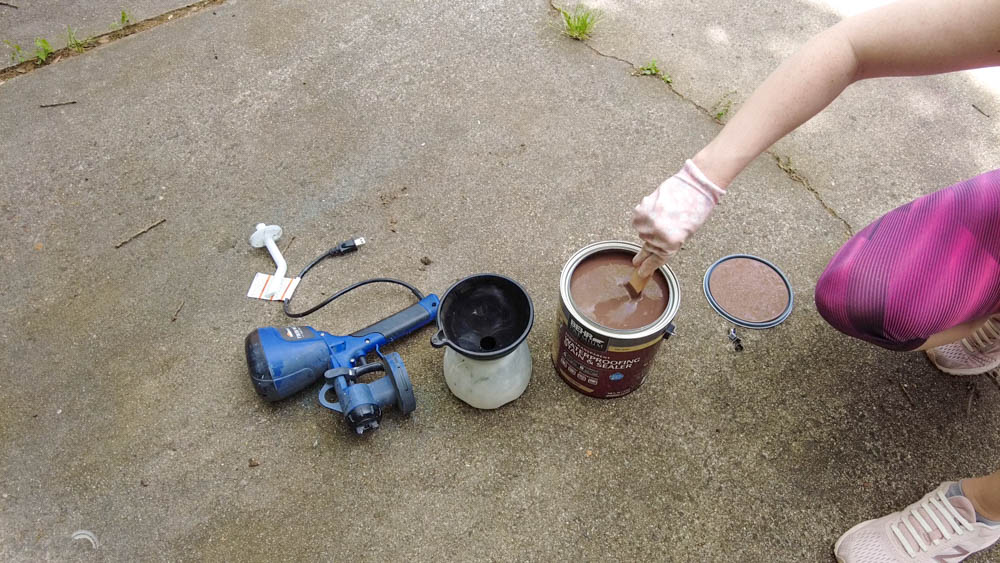 mixing up Behr semi transparent stain before using a paint sprayer to apply to a DIY wood fence