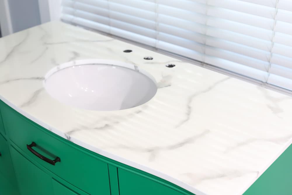 full view of painted bathroom vanity with a faux marble countertop