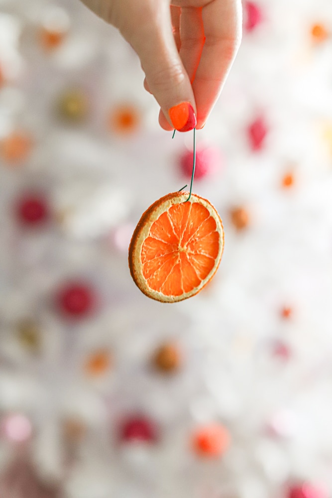 diy dried orange slice on a pink and orange christmas tree