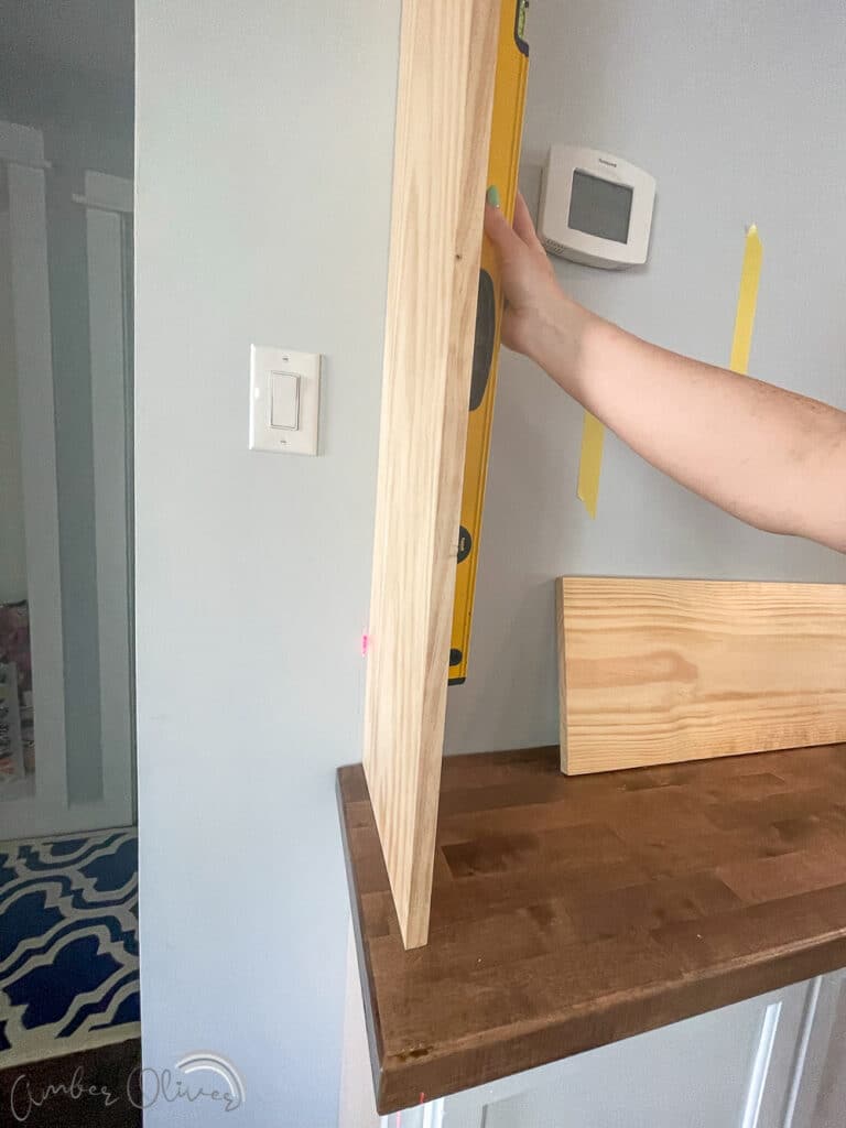 https://amber-oliver.com/wp-content/uploads/2022/06/DIY-Bookshelf-with-Built-in-Cabinets-21-768x1024.jpg