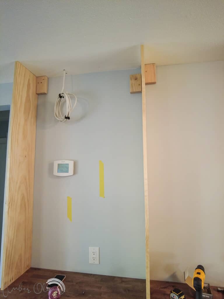 installing diy bookshelf wall on top of built in cabinets