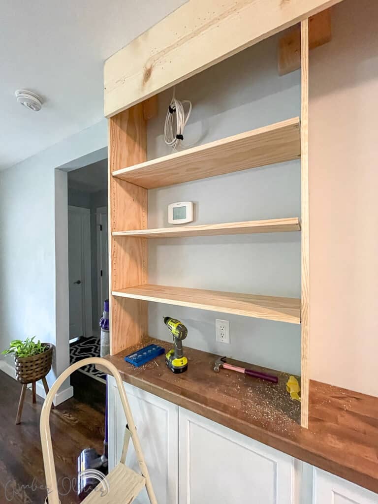 Rainbow DIY Bookshelf with Built in Cabinets - Amber Oliver