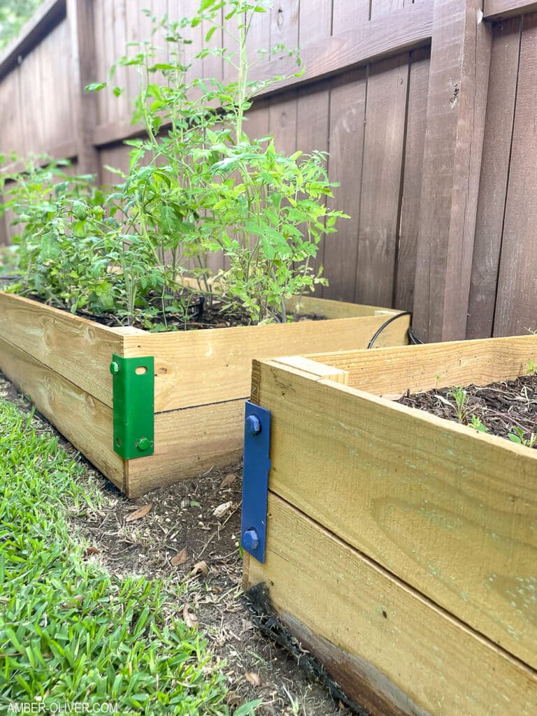 close up of diy raised garden beds with blue and green reinforcement hardware