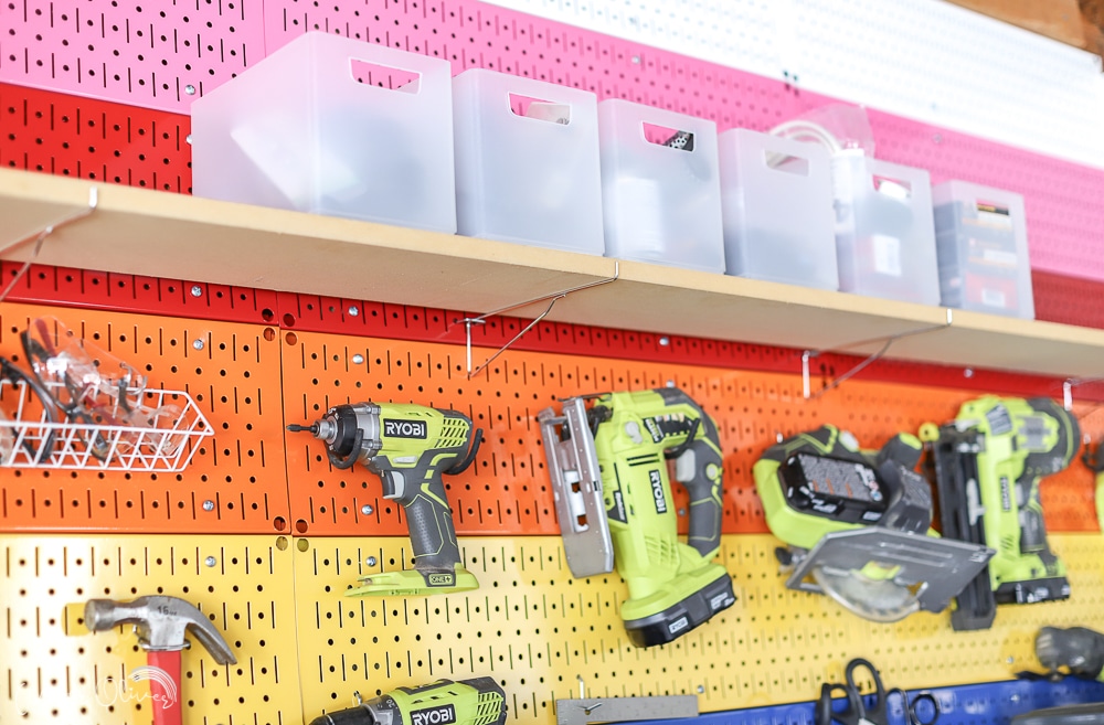 bins on pegboard shelf in organized garage