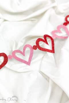 valentines garland diy with red and pink hearts on white background