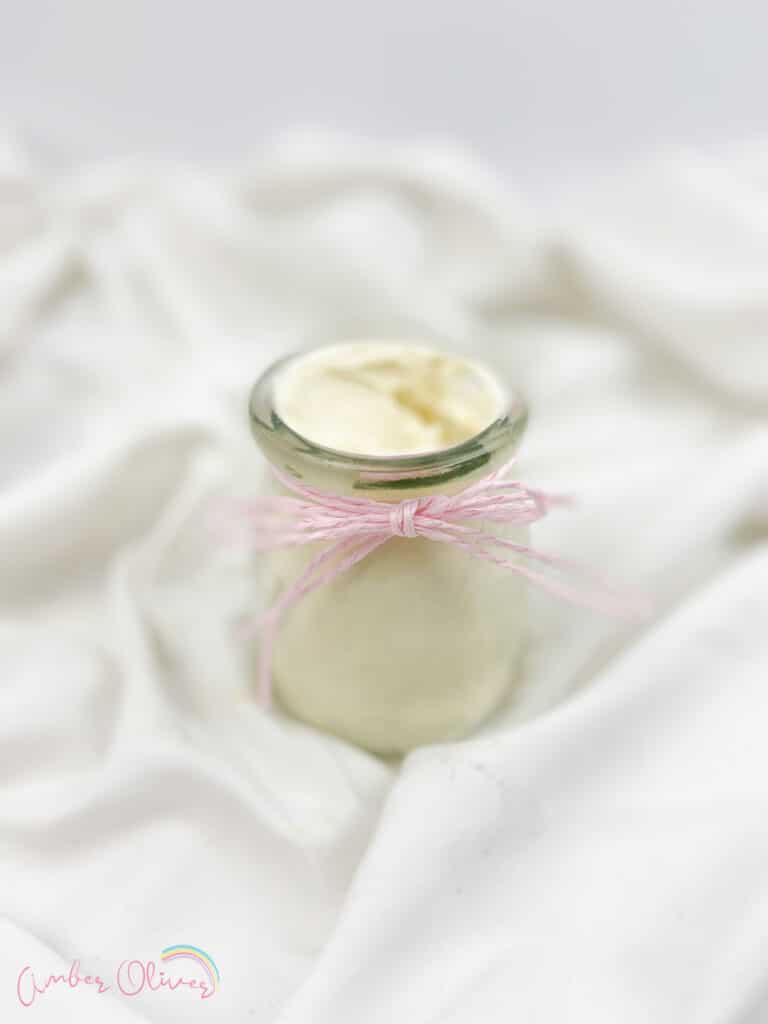 diy whipped lotion in a jar with a ribbon on a white background