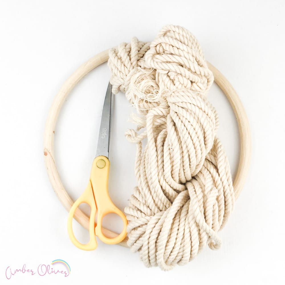 Assemble macrame cord, macrame ring/rod and scissors. Start by measuring and cutting a length of cords for your craft.