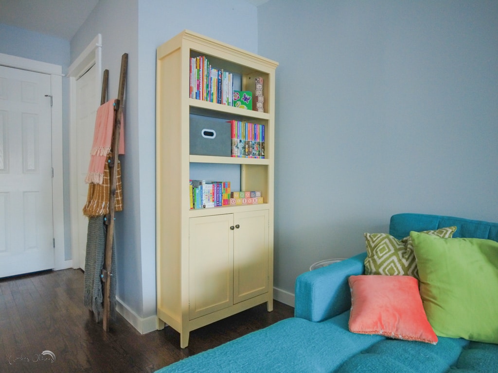 horizontal photo of laminate bookcase painted with DWIL paint