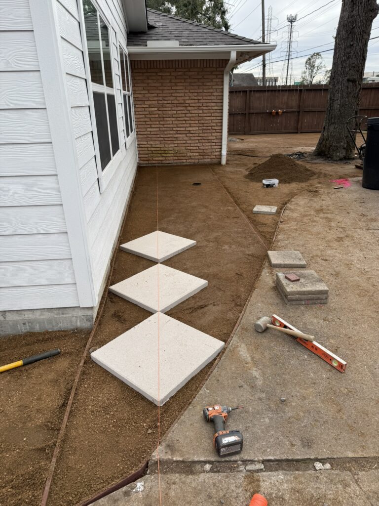 layout of patio stones during a backyard turf installation
